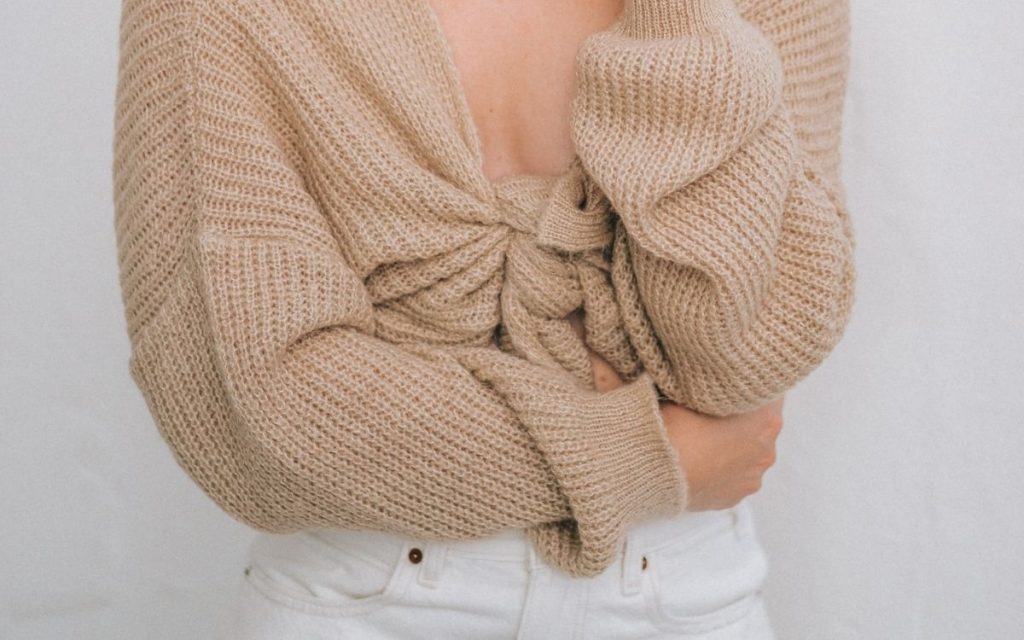 woman in soft brown cardigan sweater knotted