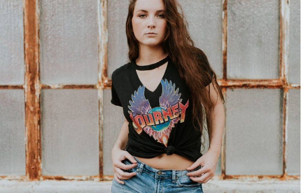 A women wearing a Journey shirt.