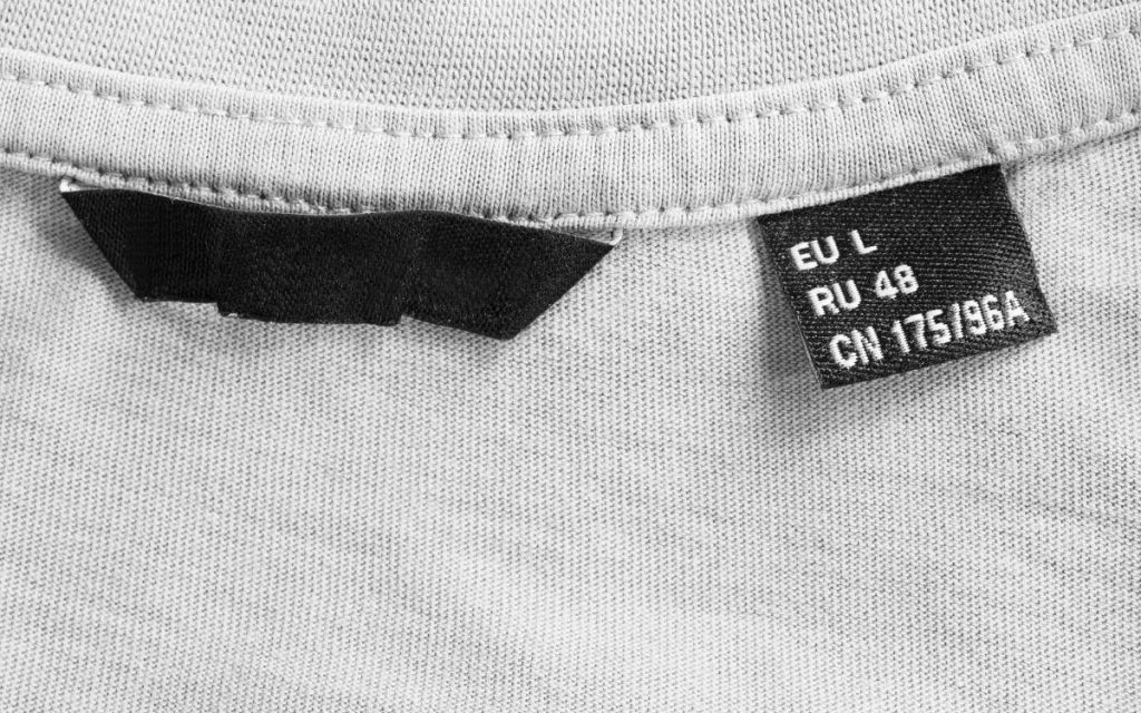Close up of a tag on a shirt showing the size of it.