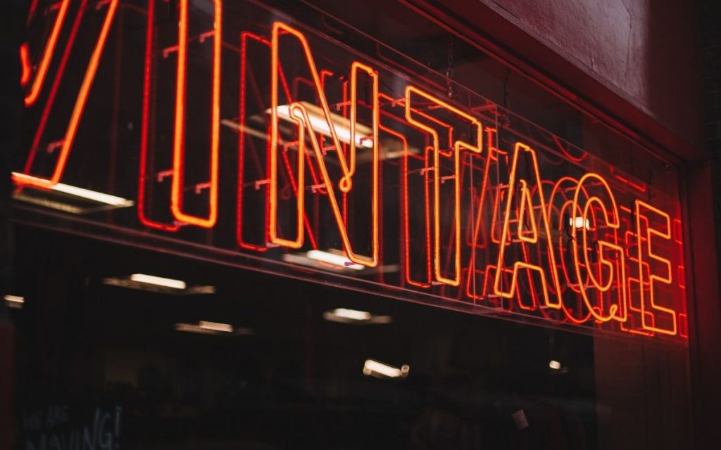 Light up neon sign in store window reads vintage.